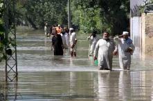 Dwellers of a village in Charsadda district of Pakistan’s Khyber Pakhtunkhwa province are wading through flood water to reach a safer place after inundation of their houses in the deluge. 