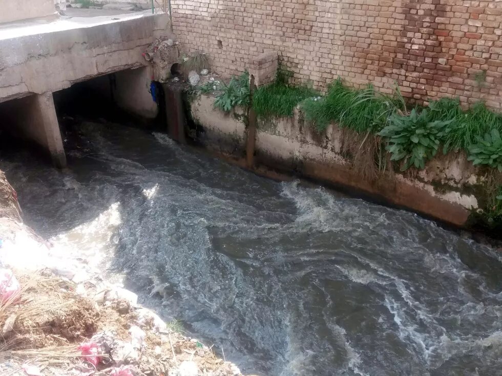 Gushing water pass through a channel to take the sanitary wastes of Peshawar