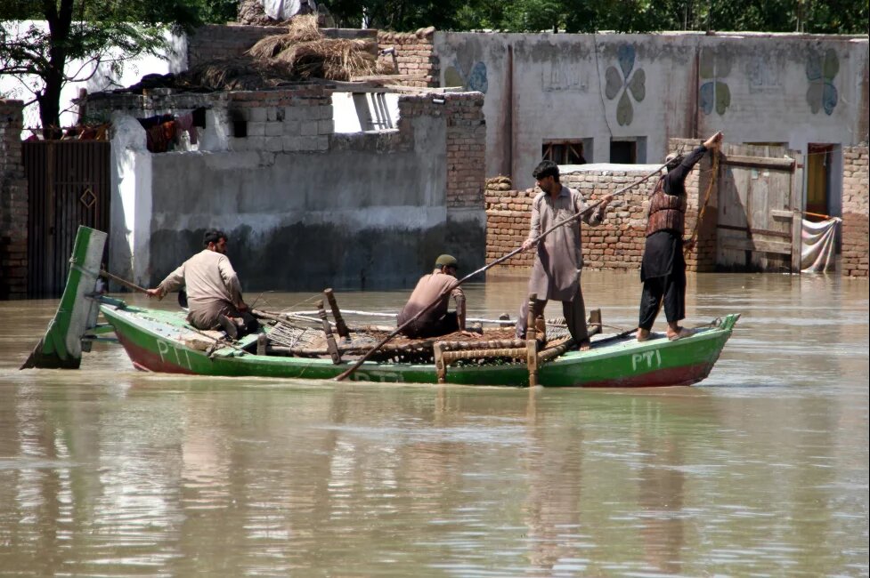 People in a flood affected area in Khyber Pakhtunkhwa are using boats for shifting to safer places along with essential household items.  